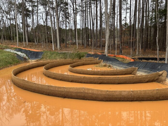 An inflow channel stabilized with geotextile liner and rip-rap.
